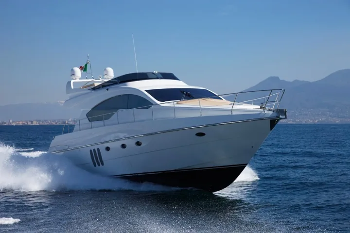 White motor yacht cruising at speed