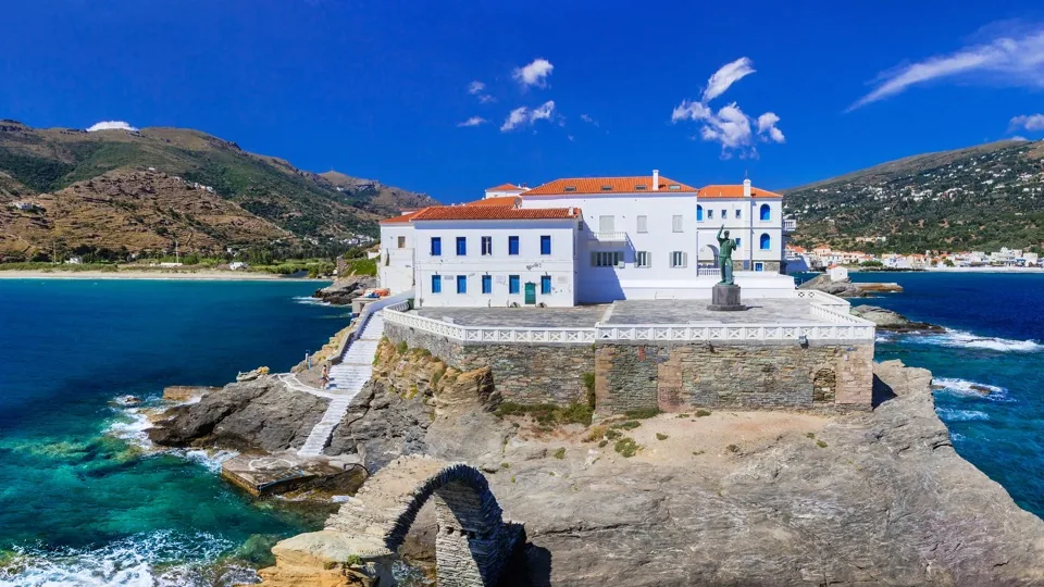 Whitewashed chapel above a Greek island cove